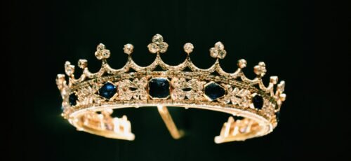 silver diamond studded crown with black background