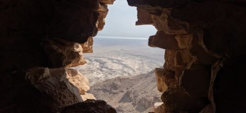 brown rock formation near body of water during daytime