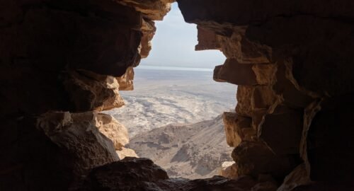 brown rock formation near body of water during daytime